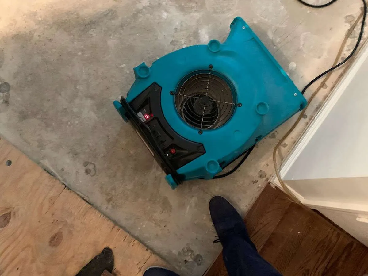 Air mover drying subfloor during Leak Detection & Repair in Armada